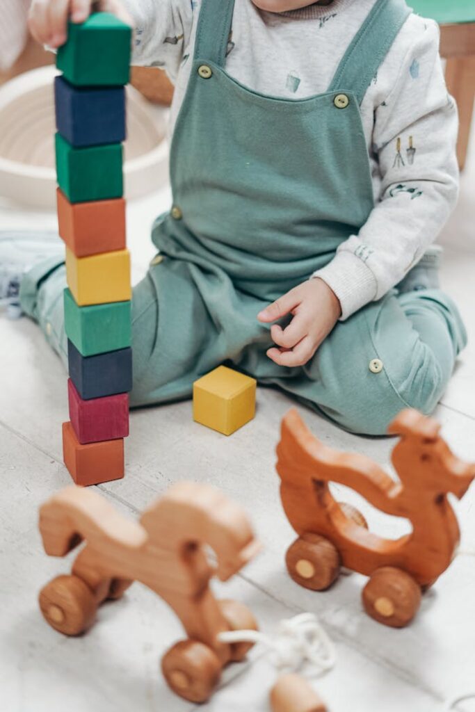pexels-photo-3661351 Child in White Long-sleeve Top and Dungaree Trousers Playing With Lego Blocks