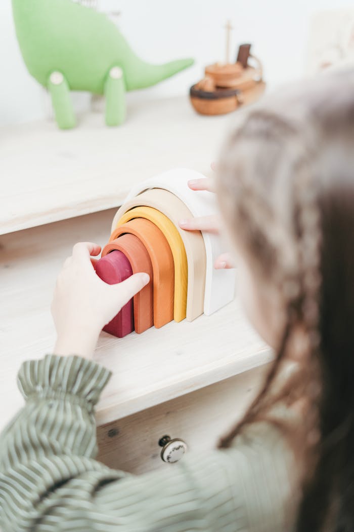 Girl Playing With Wooden Toys