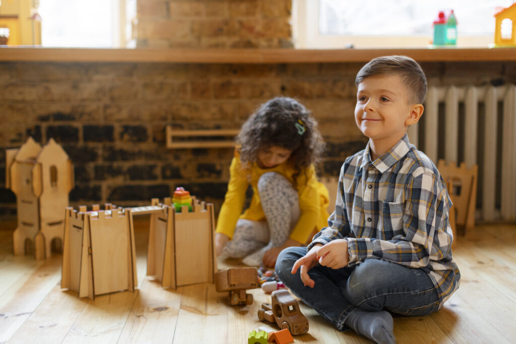 young-boy-girl-playing-indoors-with-eco-toys (1)